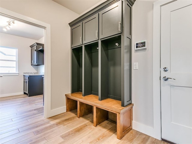 mudroom featuring light wood-type flooring and baseboards