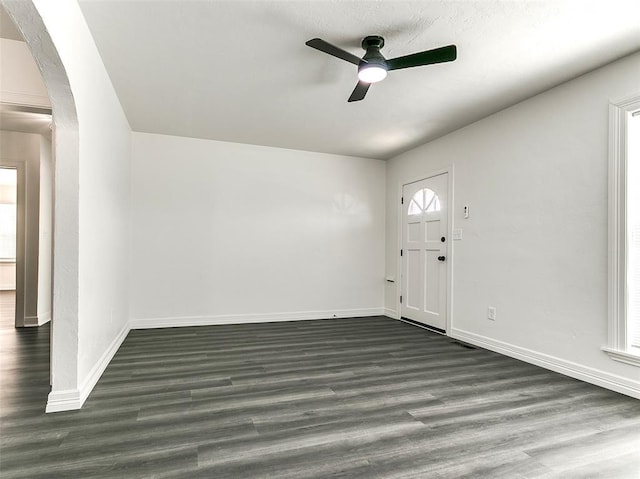 2208 N Hood St, Oklahoma City, OK 73111 - foyer entrance with ceiling fan, arched walkways, dark wood finished floors, and baseboards