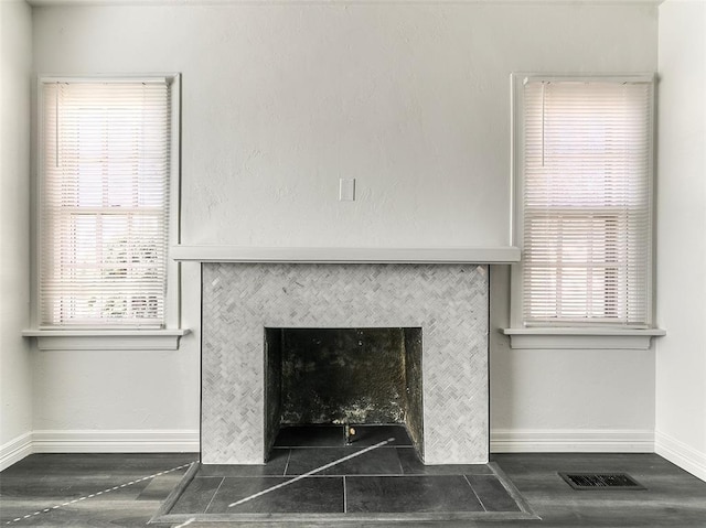 2208 N Hood St, Oklahoma City, OK 73111 - detailed view of baseboards, a tiled fireplace, and wood finished floors