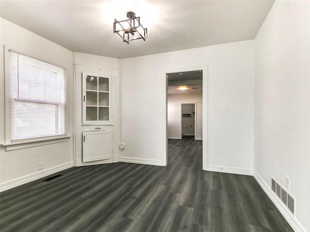 2208 N Hood St, Oklahoma City, OK 73111 - unfurnished dining area with dark wood-style floors and baseboards