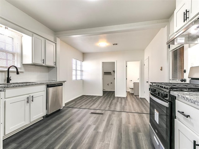 2208 N Hood St, Oklahoma City, OK 73111 - kitchen featuring gas range, dishwasher, a sink, under cabinet range hood, and dark wood-style flooring