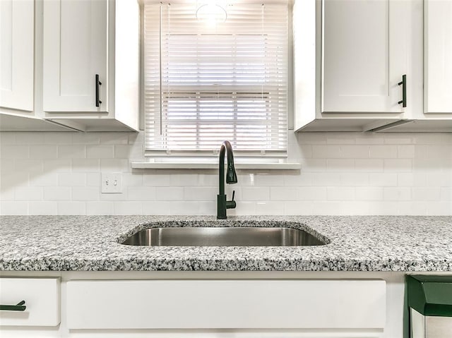 2208 N Hood St, Oklahoma City, OK 73111 - kitchen featuring a sink, white cabinetry, decorative backsplash, and light stone countertops