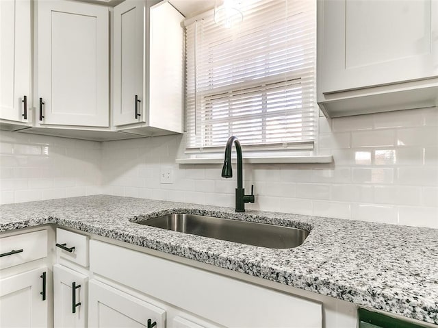 2208 N Hood St, Oklahoma City, OK 73111 - kitchen featuring a sink, white cabinets, tasteful backsplash, and light stone countertops
