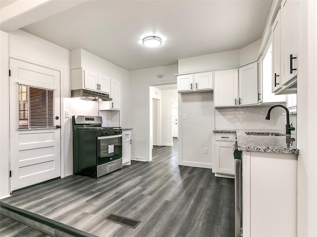 2208 N Hood St, Oklahoma City, OK 73111 - kitchen featuring stainless steel gas range oven, a sink, dark wood finished floors, under cabinet range hood, and white cabinets