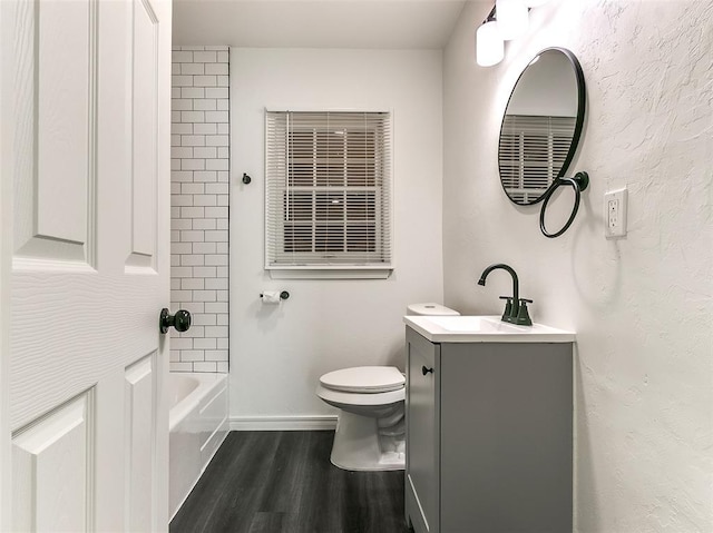 2208 N Hood St, Oklahoma City, OK 73111 - bathroom featuring vanity, wood finished floors, toilet, shower / washtub combination, and baseboards