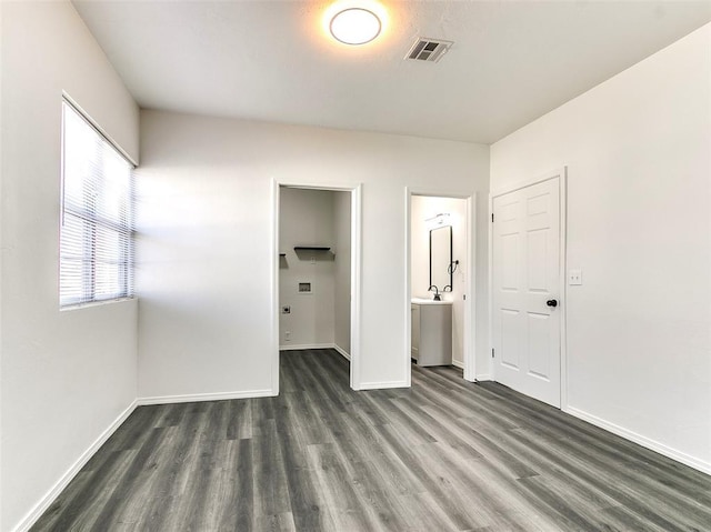 2208 N Hood St, Oklahoma City, OK 73111 - unfurnished bedroom featuring wood finished floors, baseboards, and ensuite bathroom