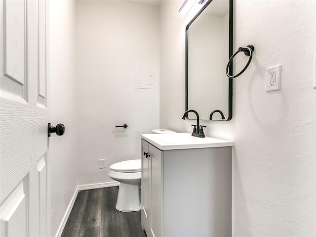 2208 N Hood St, Oklahoma City, OK 73111 - bathroom with baseboards, wood finished floors, vanity, and toilet