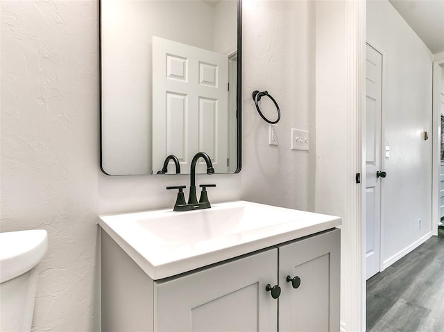 2208 N Hood St, Oklahoma City, OK 73111 - bathroom with vanity, wood finished floors, and toilet