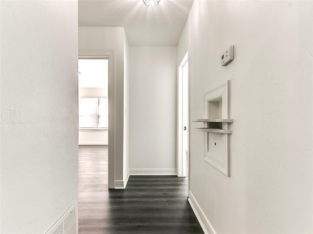 2208 N Hood St, Oklahoma City, OK 73111 - hallway with dark wood finished floors, baseboards, and a textured wall