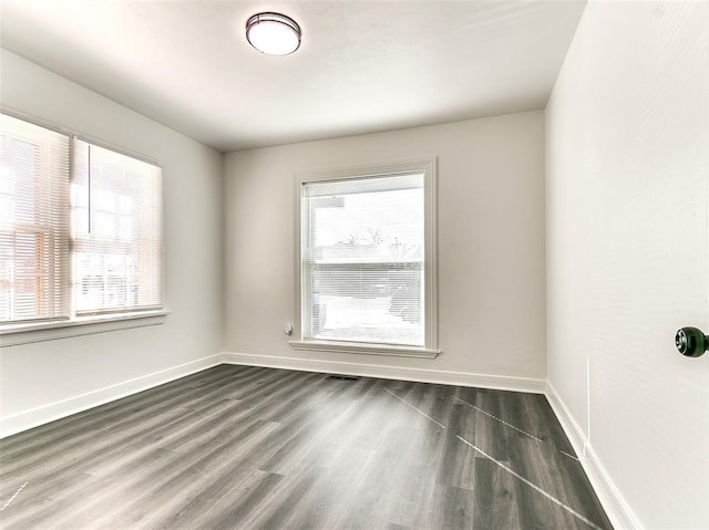 2208 N Hood St, Oklahoma City, OK 73111 - empty room featuring dark wood finished floors and baseboards