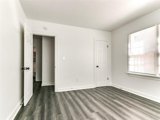 2208 N Hood St, Oklahoma City, OK 73111 - unfurnished bedroom featuring dark wood-type flooring and baseboards