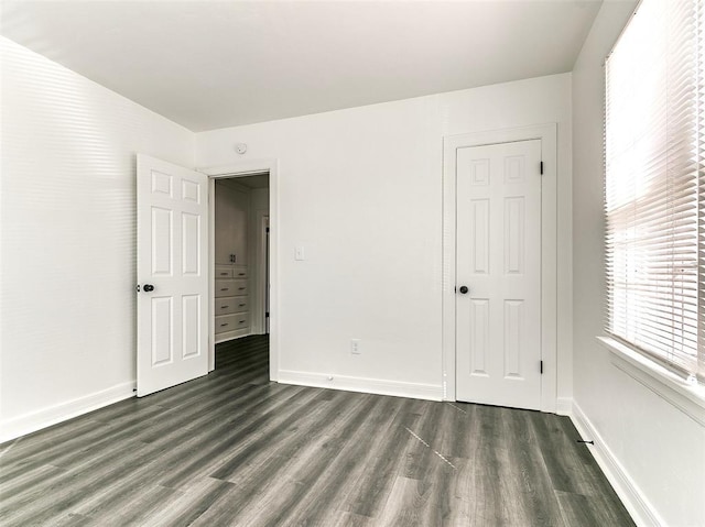 2208 N Hood St, Oklahoma City, OK 73111 - unfurnished bedroom with dark wood-style flooring and baseboards