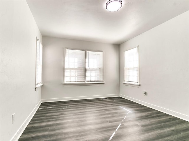 2208 N Hood St, Oklahoma City, OK 73111 - empty room featuring dark wood-style floors and baseboards