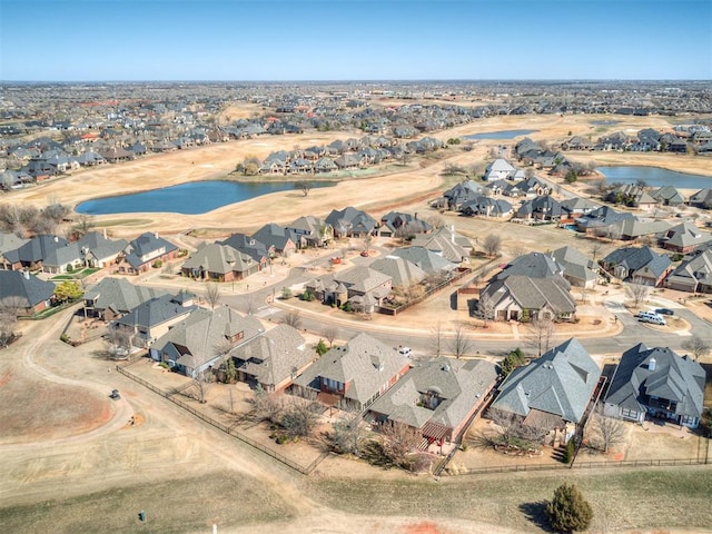 birds eye view of property featuring a water view and a residential view