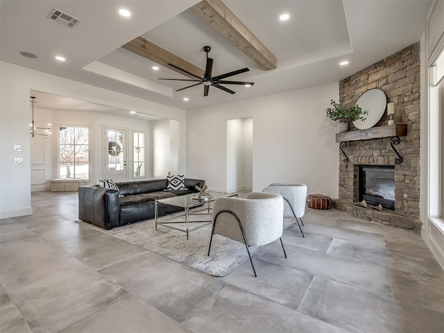 living room with visible vents, ceiling fan, beamed ceiling, a fireplace, and recessed lighting