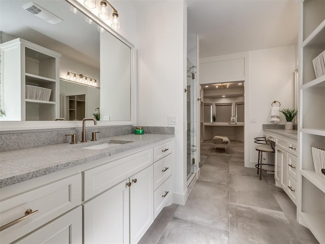 bathroom featuring a shower stall, visible vents, and vanity