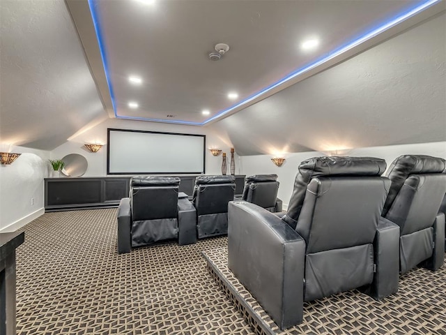 carpeted cinema featuring baseboards and vaulted ceiling