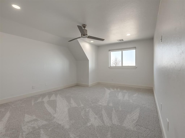 bonus room with light carpet, ceiling fan, visible vents, and baseboards