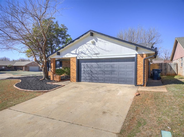 ranch-style home featuring a garage, driveway, fence, and brick siding