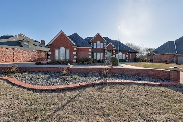 view of front facade with a front lawn and brick siding