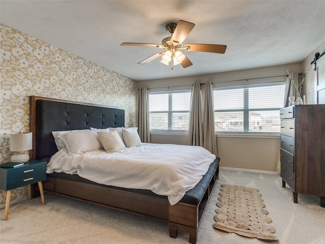 bedroom with carpet floors, a ceiling fan, baseboards, and wallpapered walls