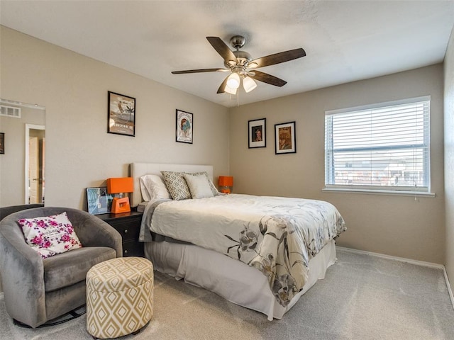 bedroom featuring a ceiling fan, visible vents, light carpet, and baseboards