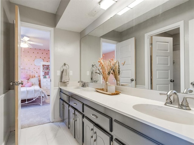 ensuite bathroom with double vanity, marble finish floor, ensuite bath, and a sink