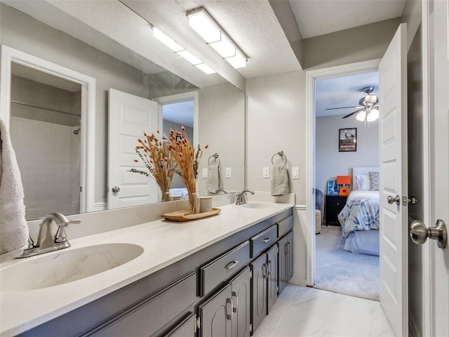 bathroom featuring marble finish floor, a sink, ensuite bath, and double vanity