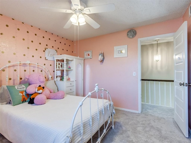 bedroom with visible vents, baseboards, a ceiling fan, a textured ceiling, and carpet floors