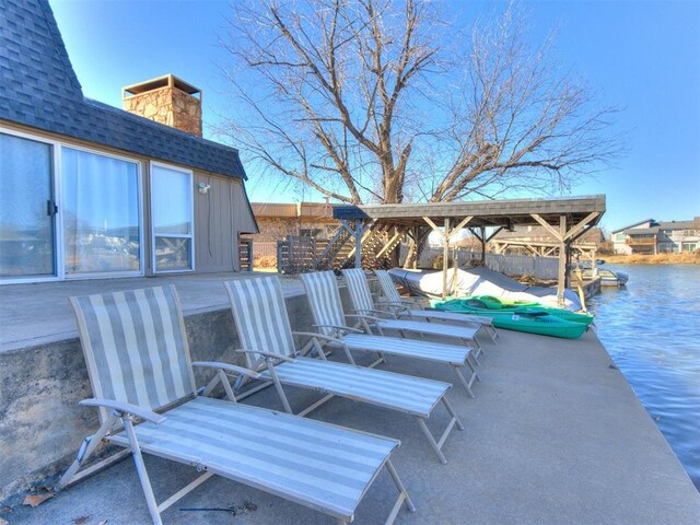 view of patio featuring a dock and a water view