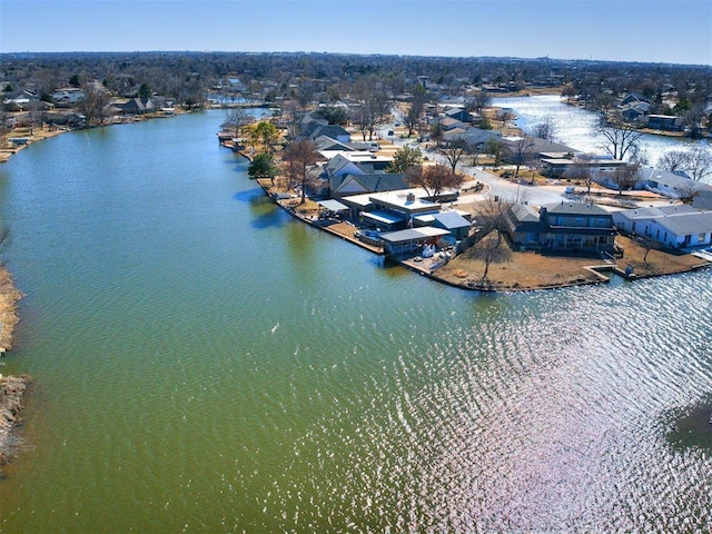 birds eye view of property with a water view and a residential view