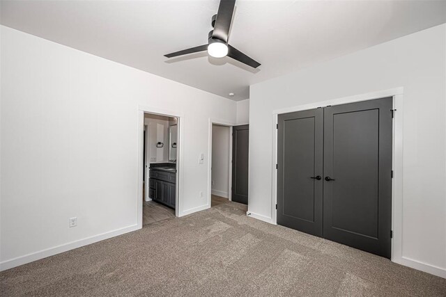 4125 Emery Dr, Edmond, OK 73034 - unfurnished bedroom featuring light colored carpet, baseboards, ensuite bathroom, and a ceiling fan