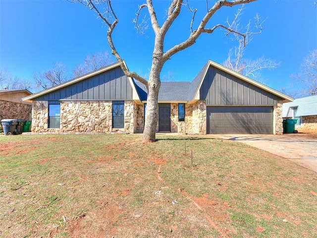 mid-century home with a garage, driveway, stone siding, board and batten siding, and a front yard