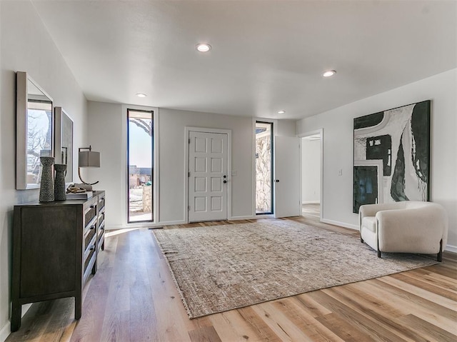 entryway with baseboards, wood finished floors, and recessed lighting