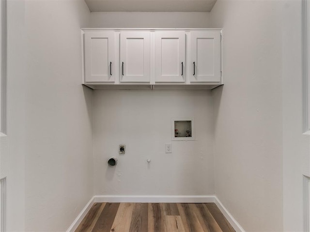 washroom with cabinet space, baseboards, dark wood-style floors, washer hookup, and electric dryer hookup