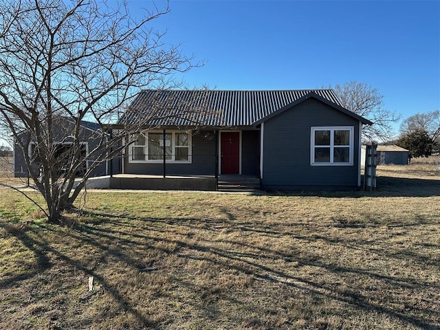 single story home with a front yard and metal roof