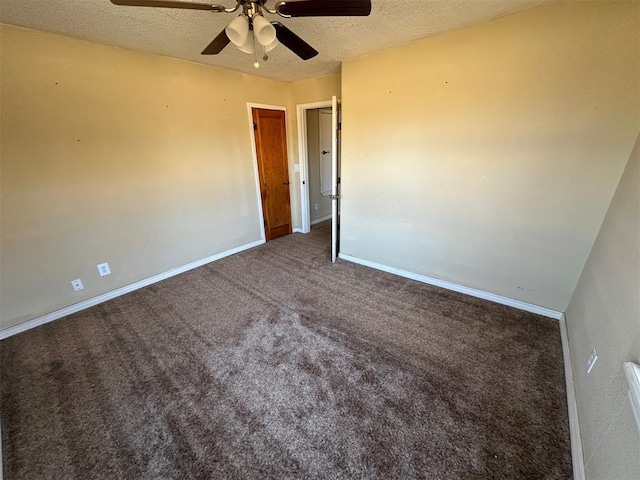 unfurnished room featuring baseboards, carpet floors, and a textured ceiling