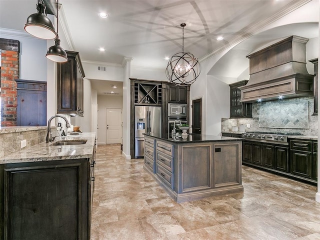 kitchen with light stone counters, a sink, stainless steel appliances, premium range hood, and backsplash