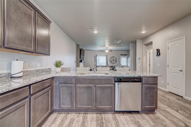 kitchen featuring visible vents, a sink, light wood-type flooring, dishwasher, and a peninsula