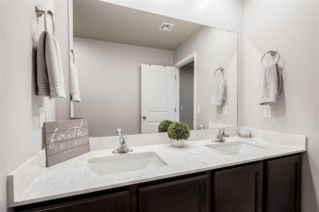 full bath featuring double vanity, a sink, and visible vents