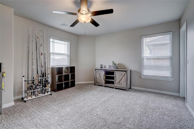 misc room featuring ceiling fan, carpet flooring, visible vents, and baseboards