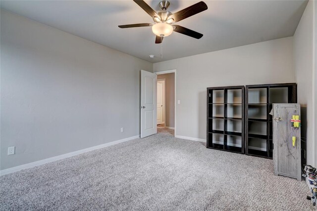 unfurnished bedroom with carpet floors, ceiling fan, and baseboards