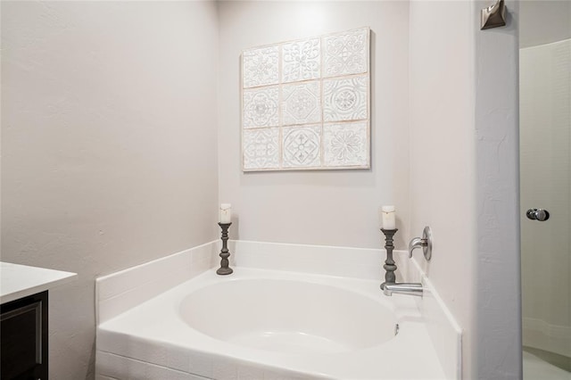 bathroom featuring a shower, vanity, and a bath