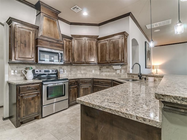 kitchen with dark brown cabinets, visible vents, appliances with stainless steel finishes, and a sink