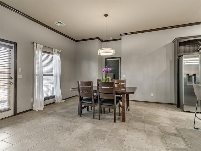 dining room with crown molding, light tile patterned flooring, baseboards, and visible vents