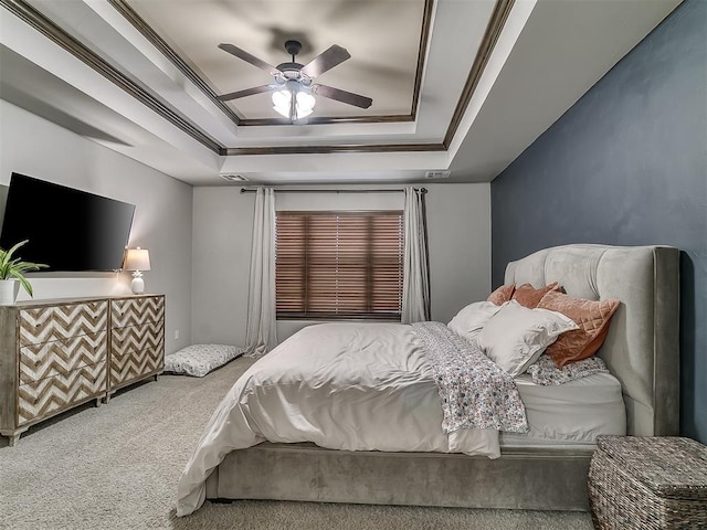 bedroom featuring a raised ceiling, carpet floors, ceiling fan, and crown molding