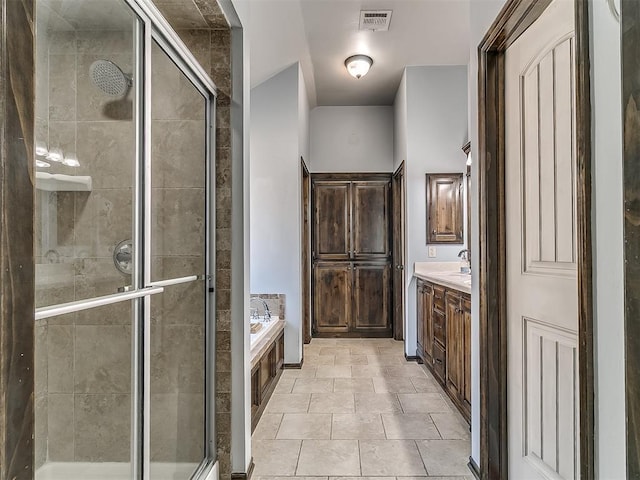 bathroom with visible vents, a stall shower, vanity, and a bath