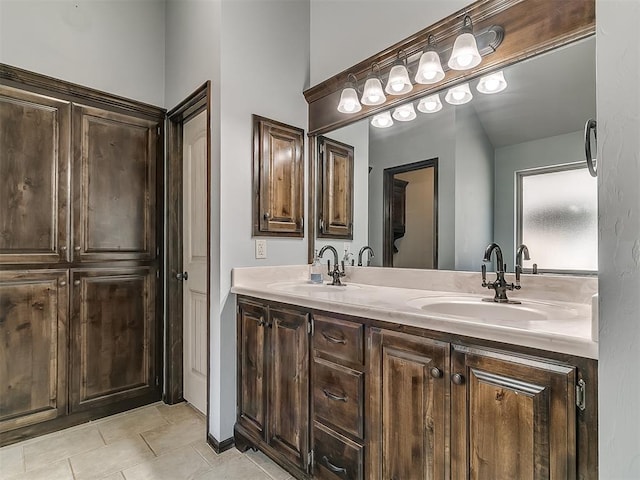 bathroom featuring double vanity, tile patterned flooring, and a sink