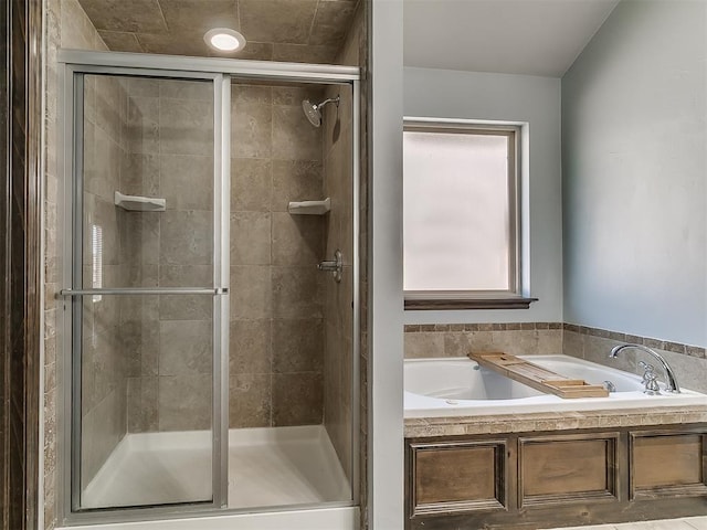 bathroom with a garden tub and a shower stall