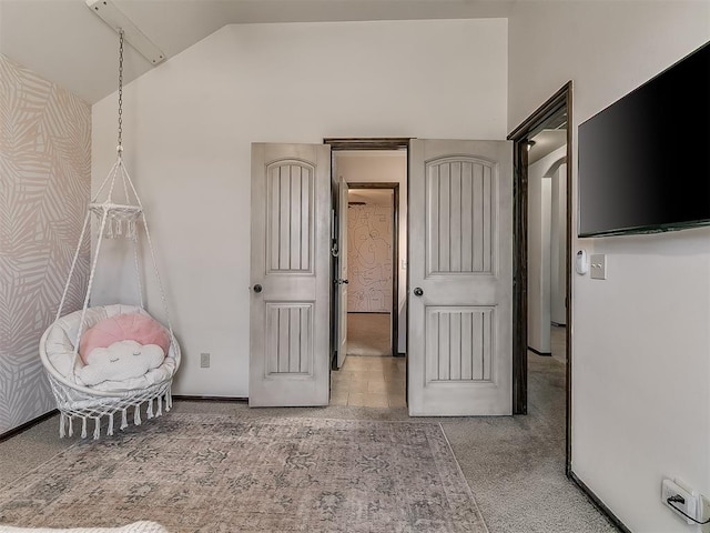 unfurnished bedroom with high vaulted ceiling, carpet, and baseboards